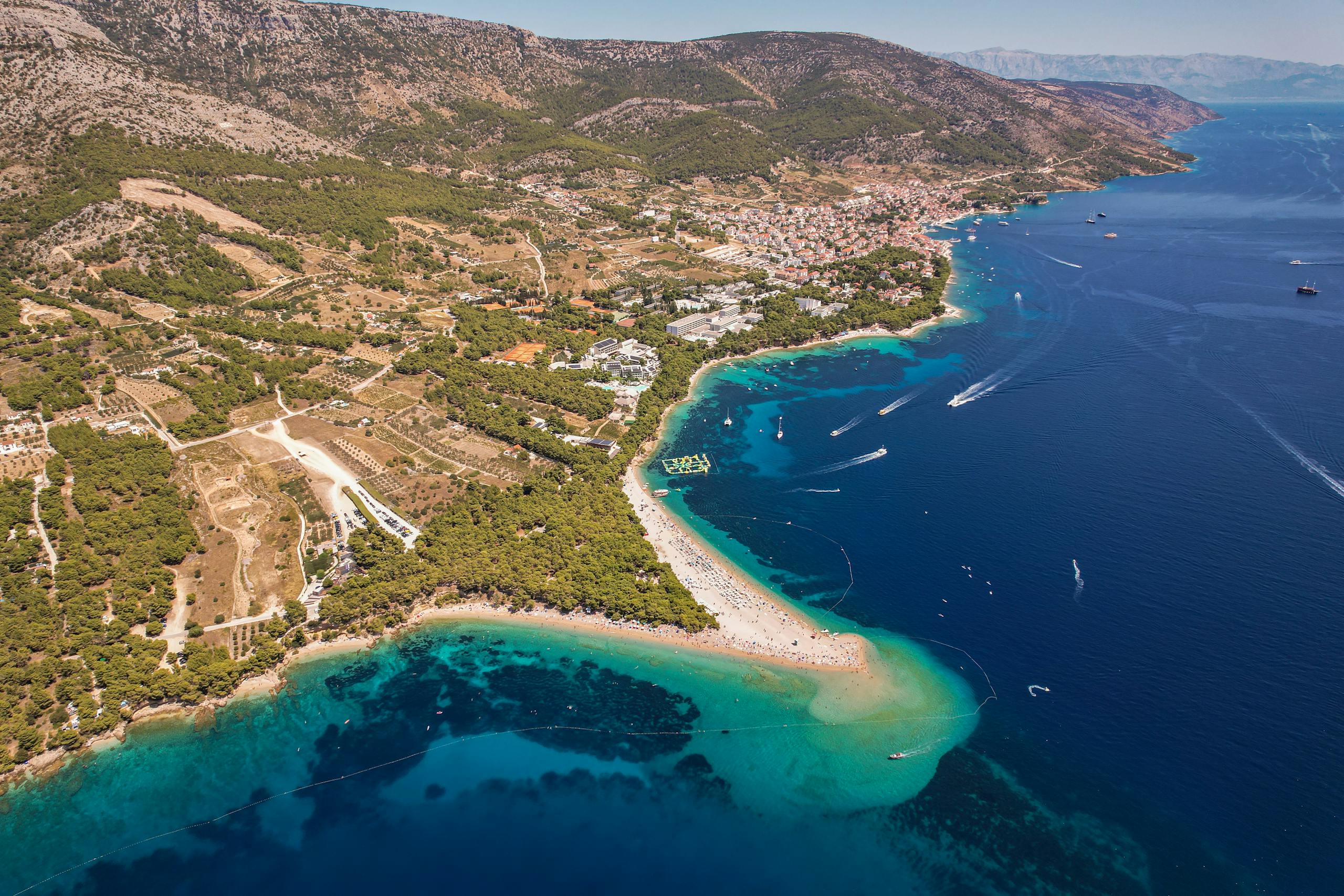 A breathtaking aerial shot capturing a stunning coastline and turquoise waters.